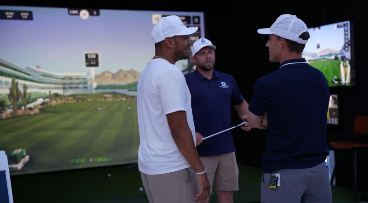 On The Green Studios team speaking with guests at a golf simulator event