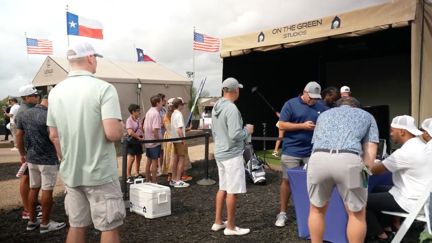 Attendees lined up for the On The Green Studios golf simulator experience