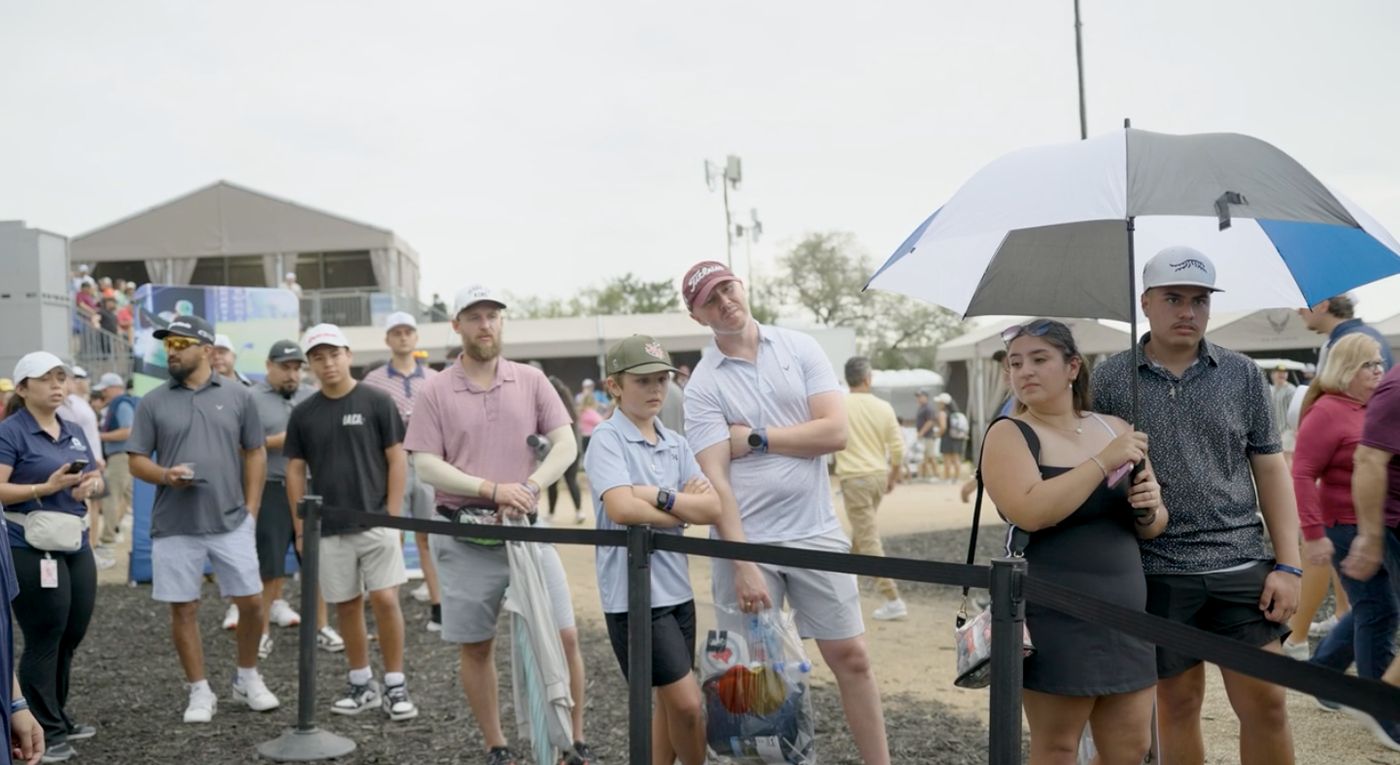 Event attendees waiting to participate in the mobile golf simulator experience